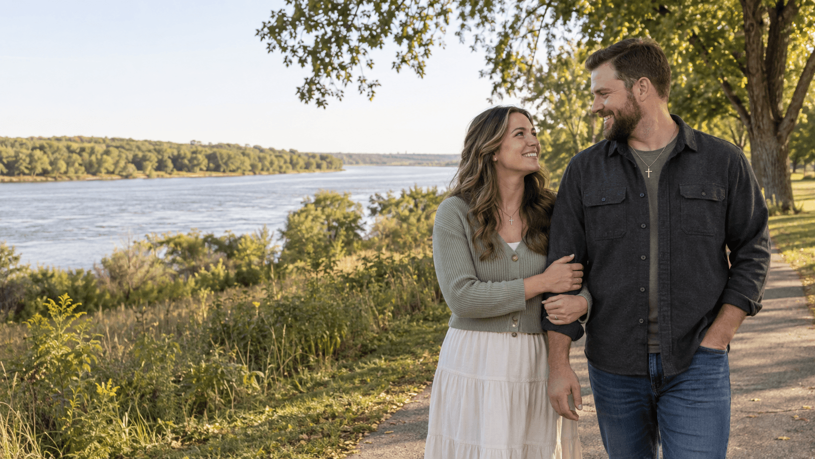 Christian couple near a tree-lined Missouri River setting at Pioneer Park in Bismarck.