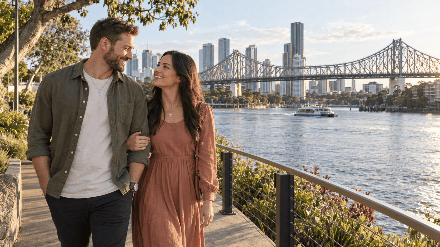 Couple wearing cross necklaces on the Brisbane riverfront with Story Bridge in the background.
