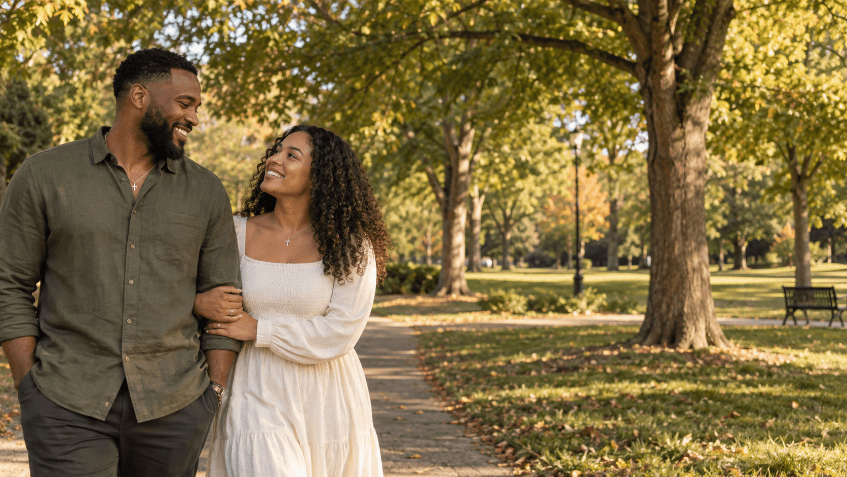 Couple wearing cross necklaces on a leafy Freedom Park-inspired path in Charlotte.