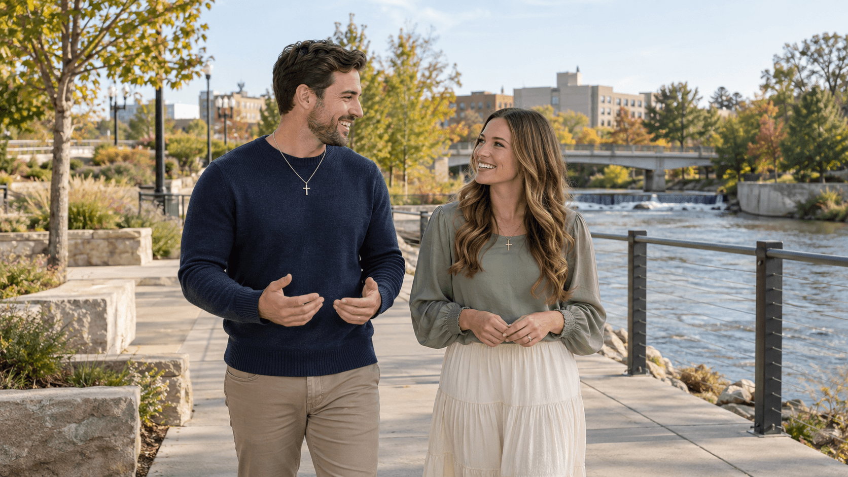 Couple wearing cross necklaces in a Fort Wayne-inspired riverside park.