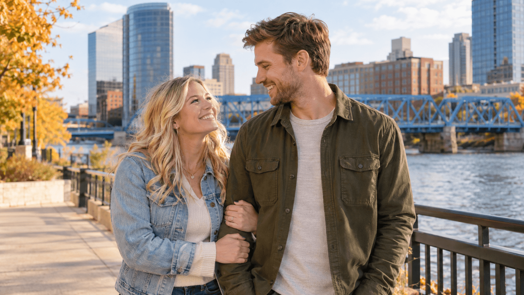 Couple wearing cross necklaces near a Grand River pedestrian bridge in a Grand Rapids-inspired scene.