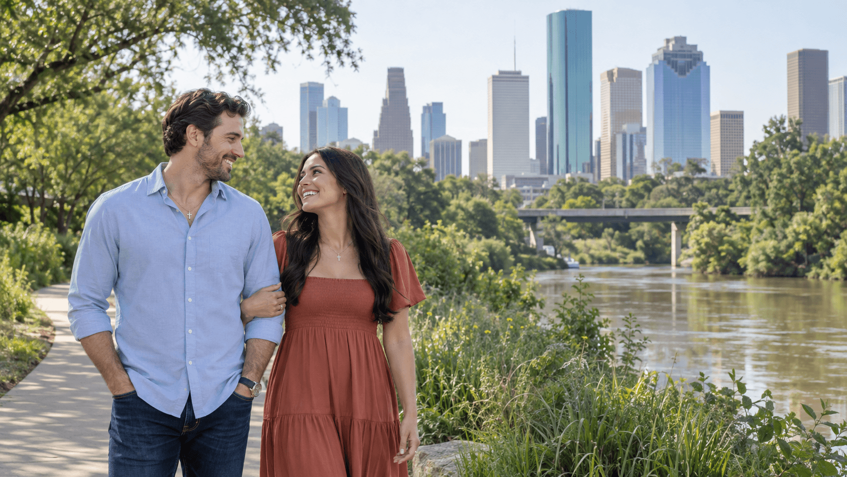 Christian couple on a Buffalo Bayou Park path with the Houston skyline beyond.