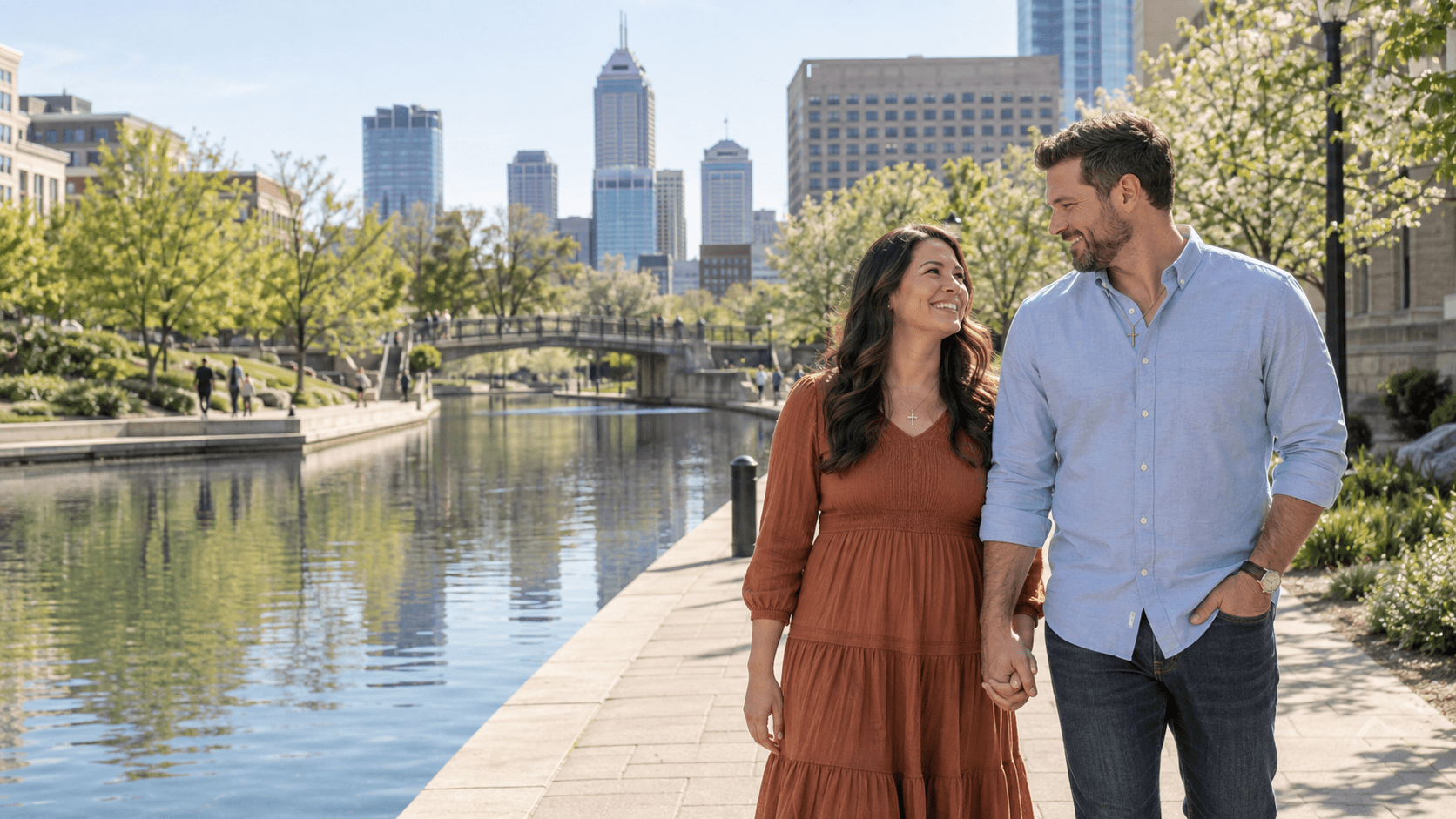 Couple wearing cross necklaces beside an Indianapolis-inspired downtown canal.
