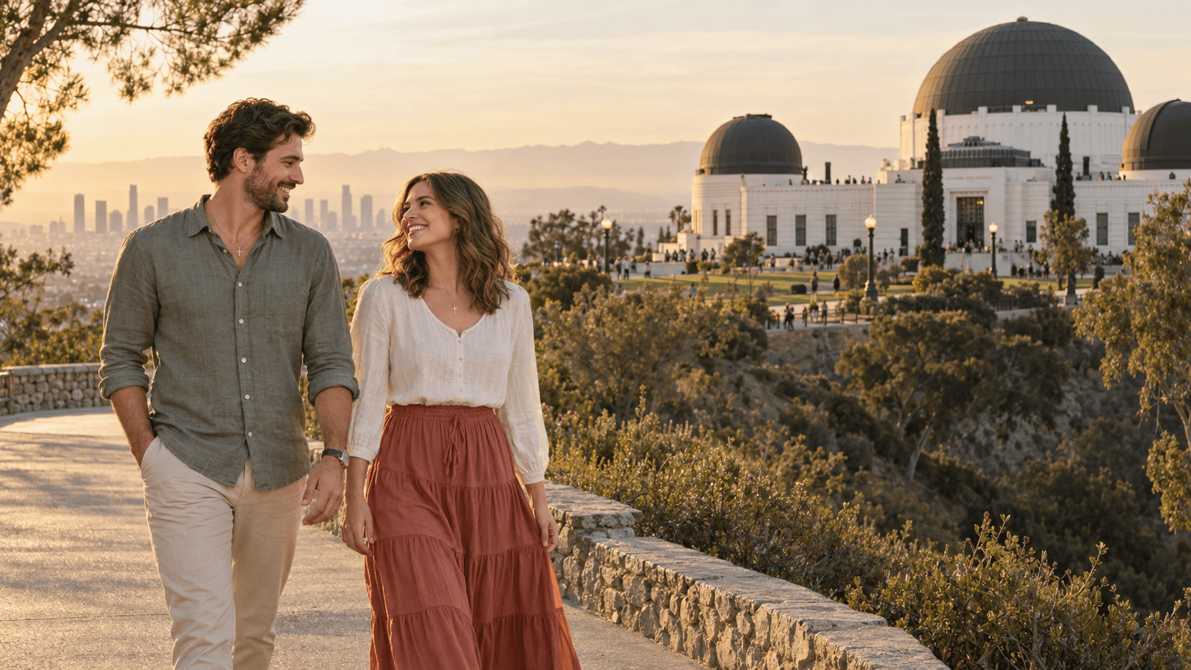 Couple wearing cross necklaces near Griffith Observatory in a warm Los Angeles-inspired evening scene.