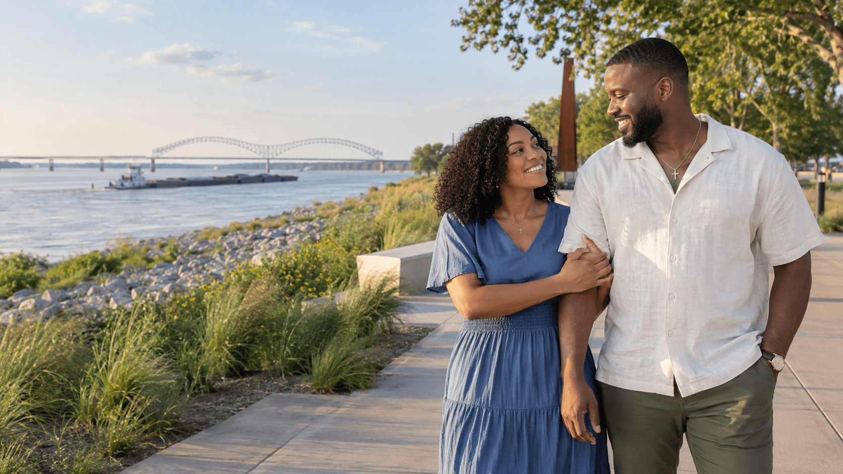 Couple wearing cross necklaces beside the Mississippi River at Tom Lee Park in Memphis.