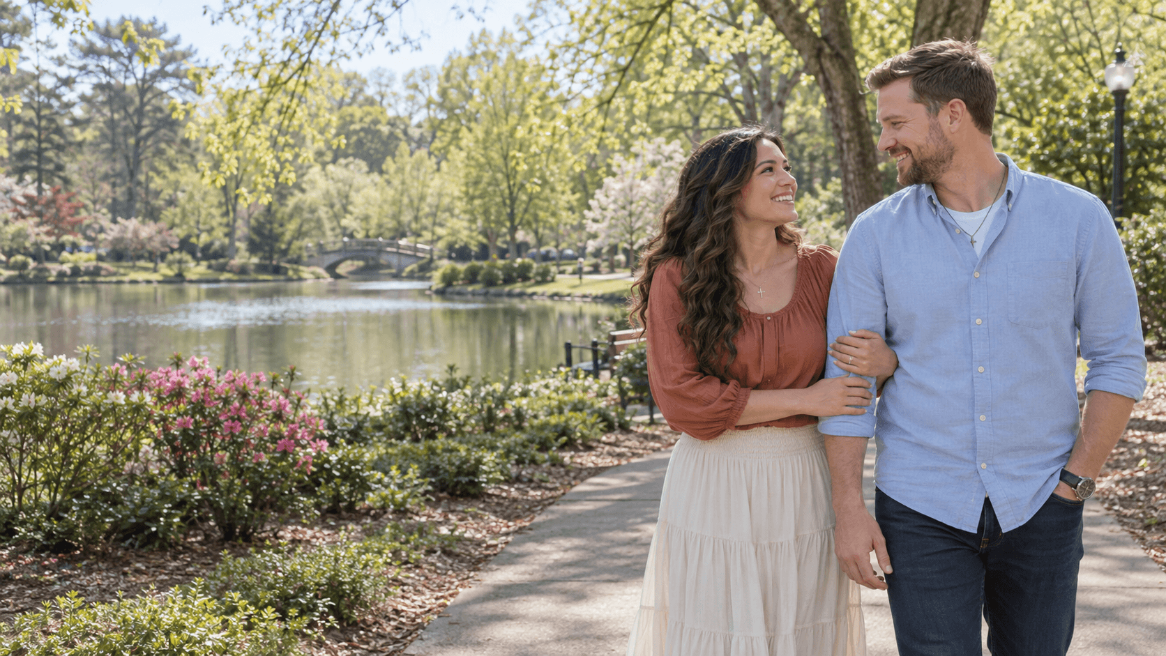 Christian couple walking beside greenery in a Pullen Park-inspired setting in Raleigh.