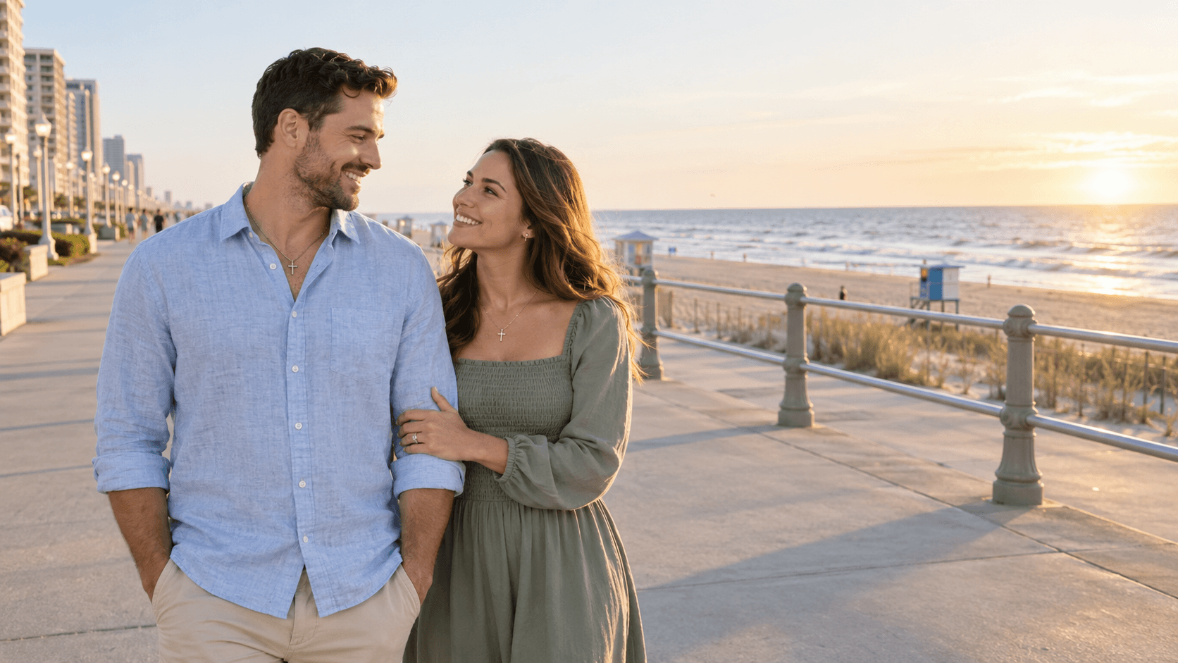 Christian couple on the Virginia Beach Boardwalk with the Atlantic Ocean behind them.